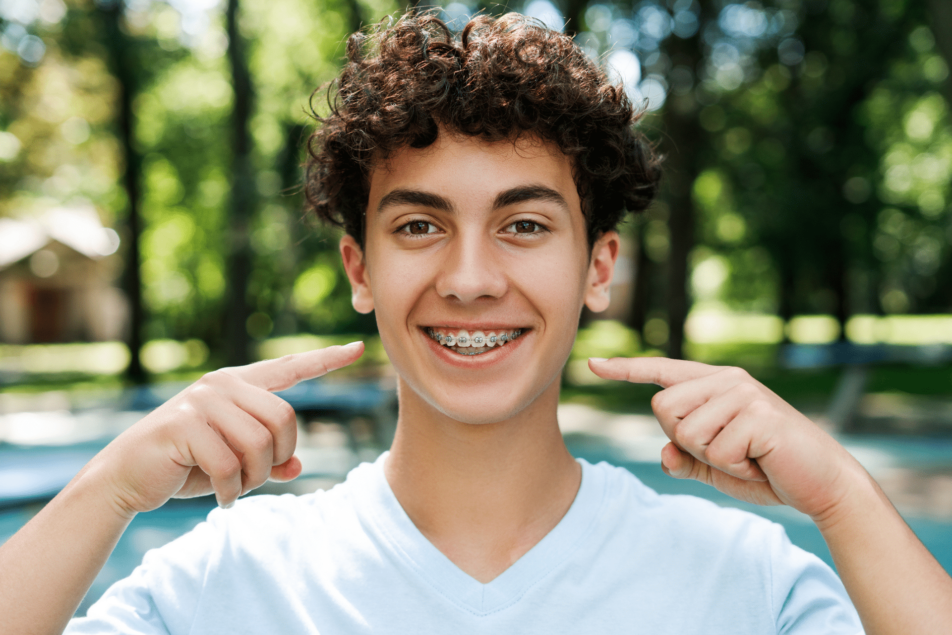 Teen smiling with braces during summer activities in San Antonio, TX