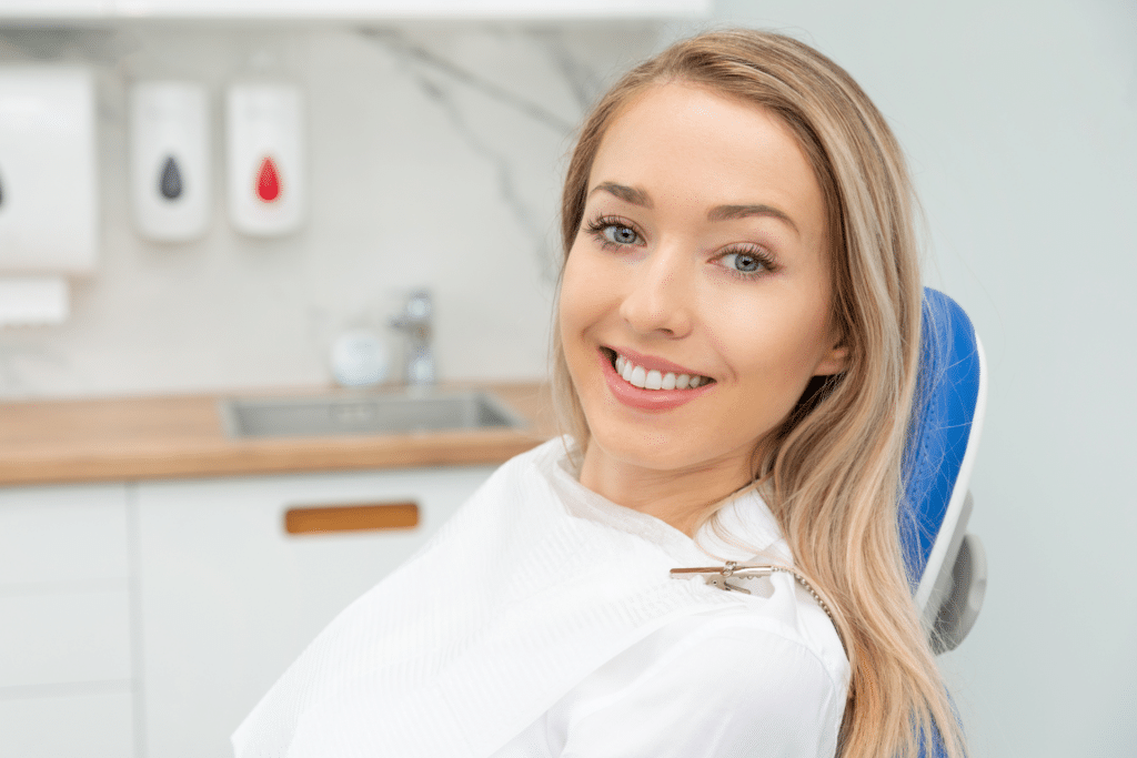 Smiling woman seated in a dental chair during an orthodontic visit