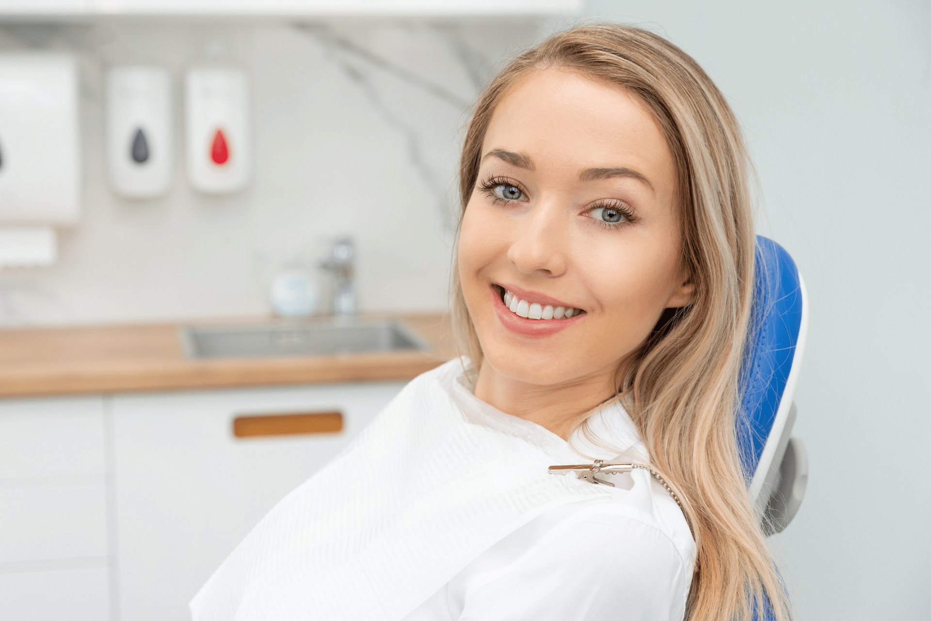 Smiling woman seated in a dental chair during an orthodontic visit